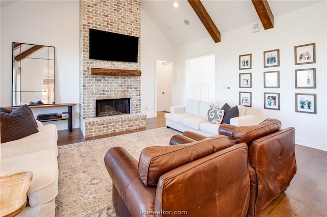 living room with a fireplace, dark hardwood / wood-style flooring, and beamed ceiling