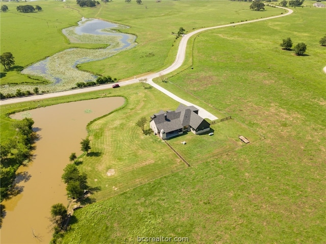 birds eye view of property with a rural view and a water view