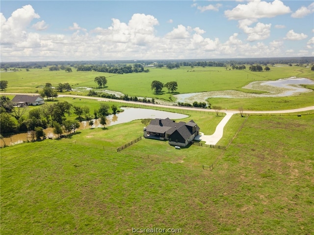 birds eye view of property featuring a water view and a rural view