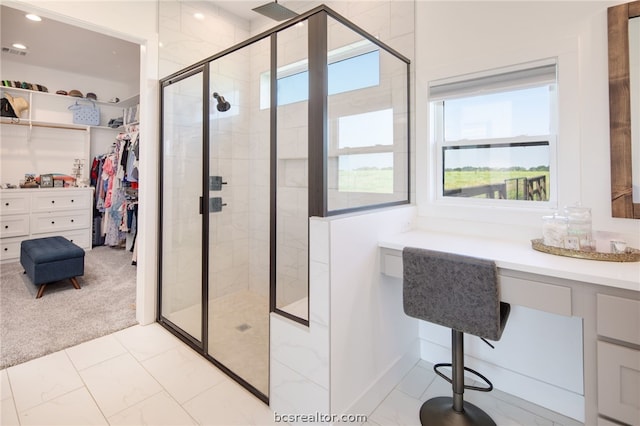 bathroom featuring a wealth of natural light and a shower with shower door