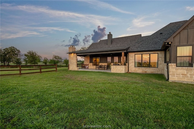 back of house with a yard and a patio area