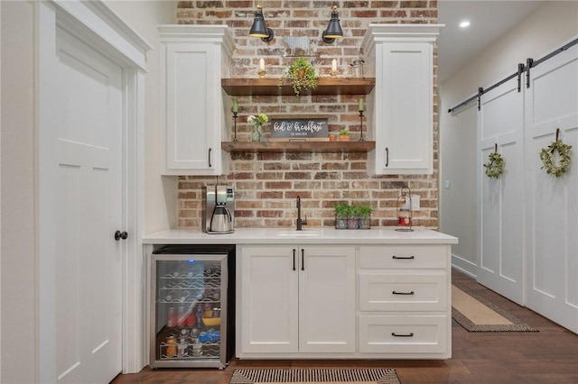5026 Yellow Tanager Ct, College Station, TX 77845 - indoor wet bar with beverage cooler, a barn door, dark wood-style floors, and backsplash