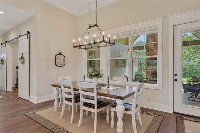 5026 Yellow Tanager Ct, College Station, TX 77845 - dining space featuring a barn door, baseboards, wood finished floors, and a chandelier