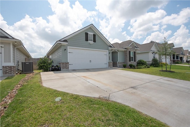 view of front of property featuring cooling unit, a front yard, and a garage