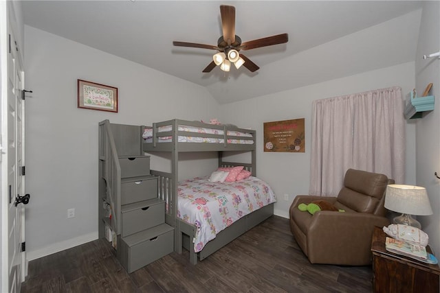 bedroom featuring ceiling fan, dark wood-type flooring, and lofted ceiling