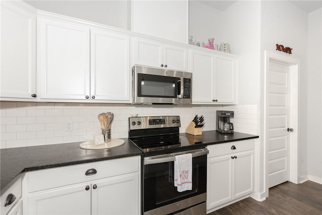 kitchen with tasteful backsplash, dark hardwood / wood-style flooring, white cabinets, and stainless steel appliances