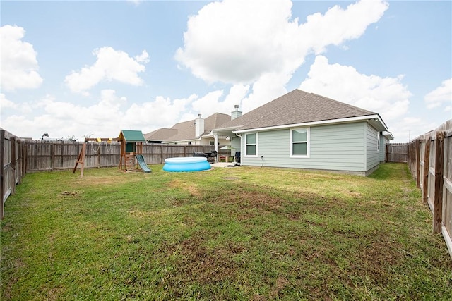 view of yard featuring a playground and a pool