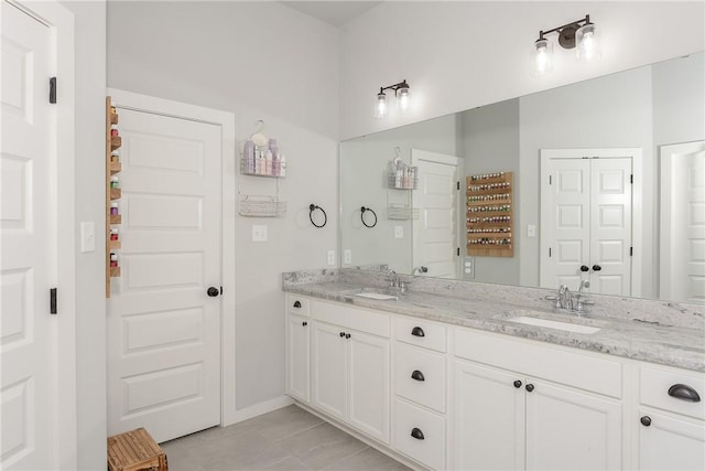 bathroom featuring tile patterned flooring and vanity