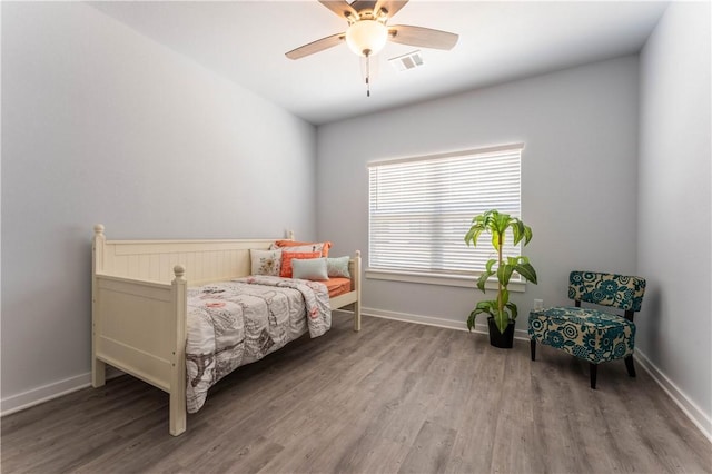 bedroom with ceiling fan and wood-type flooring