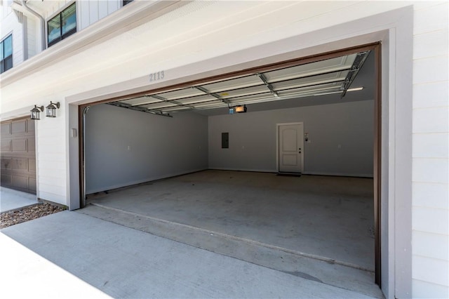 garage featuring a garage door opener and electric panel