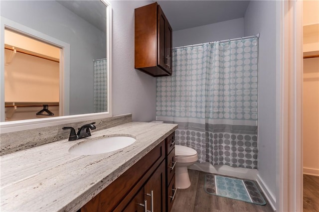 bathroom with vanity, toilet, and hardwood / wood-style floors