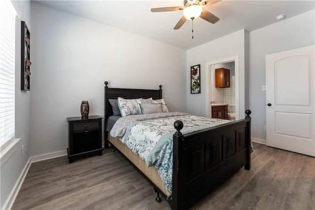 bedroom with ceiling fan, connected bathroom, and dark hardwood / wood-style flooring