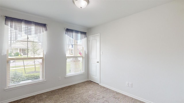 1924 Cartwright St, Bryan, TX 77807 - empty room featuring plenty of natural light, baseboards, and carpet
