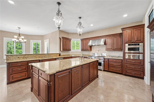 4727 Johnson Creek Loop, College Station, TX 77845 - kitchen with appliances with stainless steel finishes, wall chimney range hood, a chandelier, a warming drawer, and a center island with sink