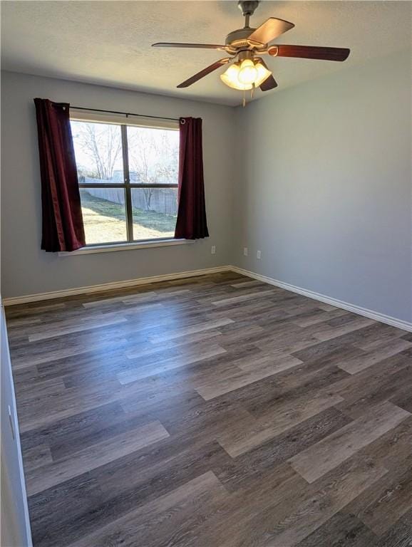 empty room featuring dark hardwood / wood-style flooring and ceiling fan