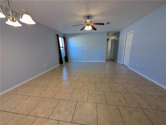 spare room featuring ceiling fan with notable chandelier