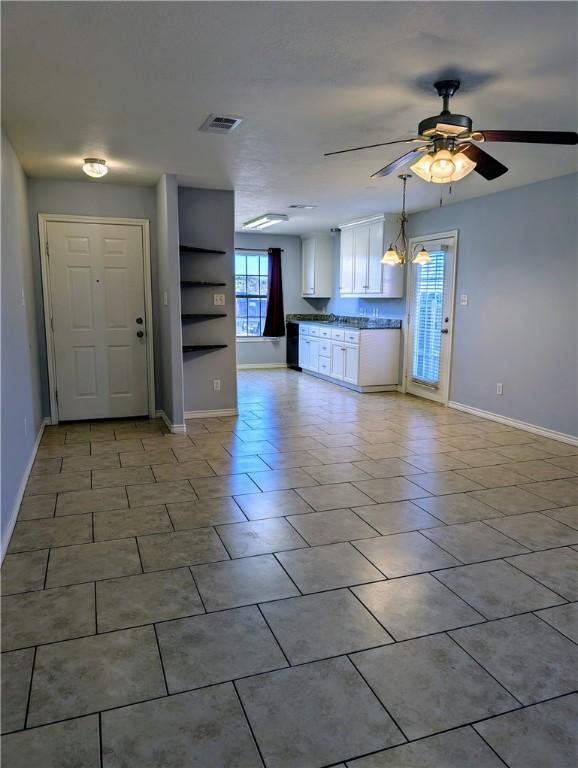 unfurnished living room with light tile patterned flooring and ceiling fan