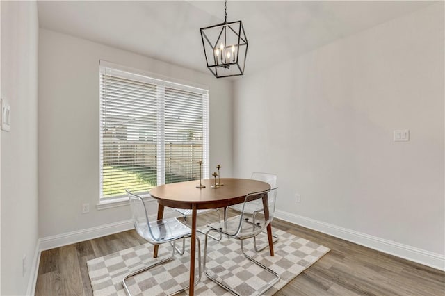 dining area with a notable chandelier and wood-type flooring