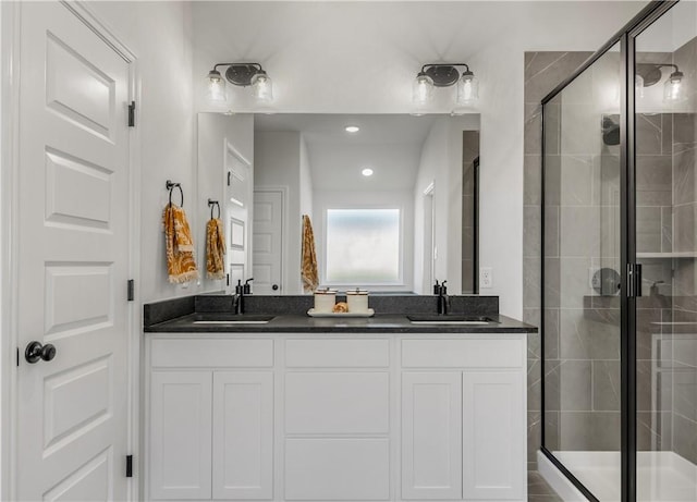 bathroom featuring vanity and a shower with door