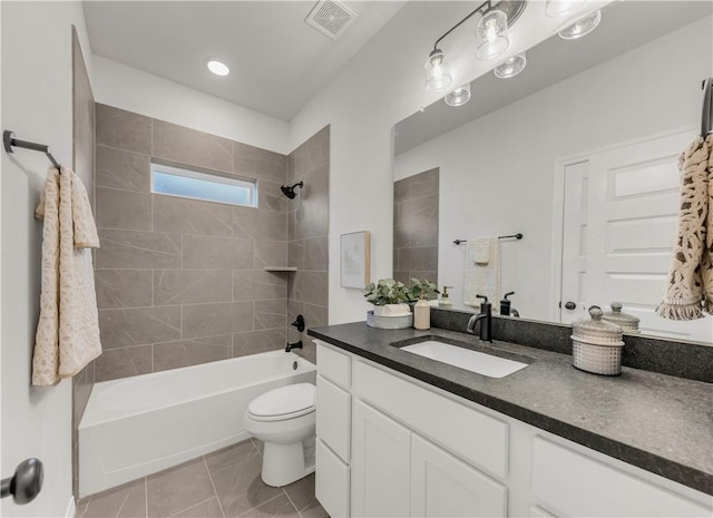 full bathroom with tile patterned floors, toilet, vanity, and tiled shower / bath