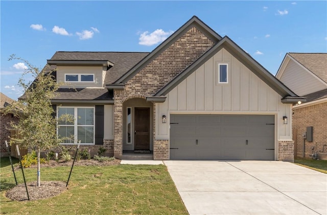 view of front of house featuring driveway, an attached garage, brick siding, a front lawn, and board and batten siding