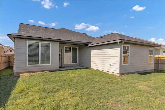 rear view of property featuring a yard