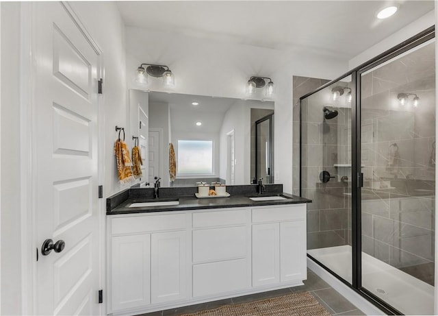 bathroom featuring vanity, tile patterned floors, and a shower with shower door