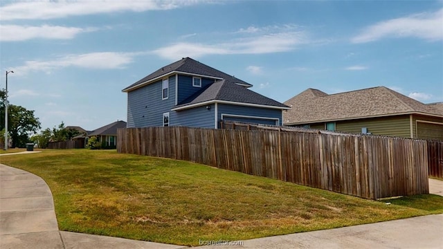 view of side of home featuring a yard