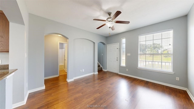 spare room featuring dark hardwood / wood-style flooring and ceiling fan