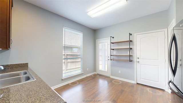 kitchen featuring sink, fridge, and dark hardwood / wood-style flooring