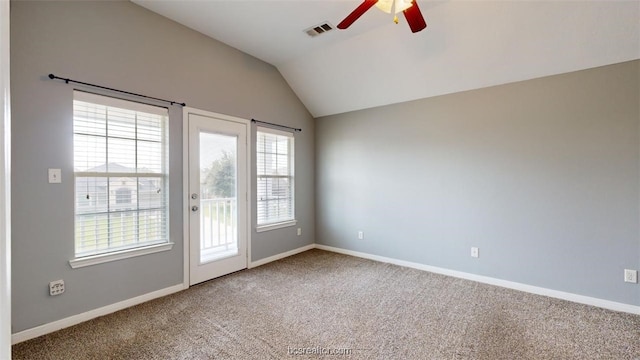 doorway with vaulted ceiling, ceiling fan, and carpet flooring