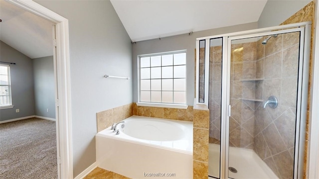 bathroom featuring lofted ceiling and shower with separate bathtub