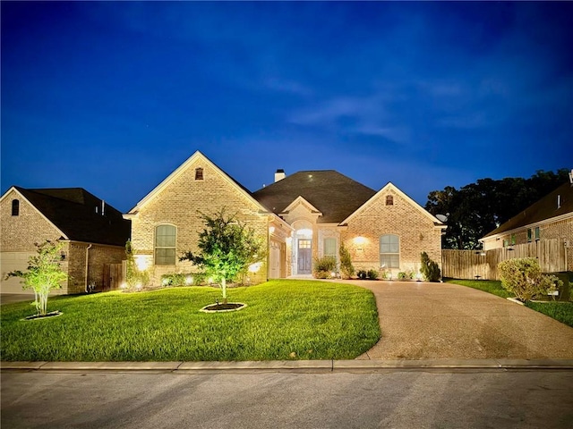 3204 Ashville Path, Bryan, TX 77808 - french provincial home featuring brick siding, a chimney, a garage, and concrete driveway