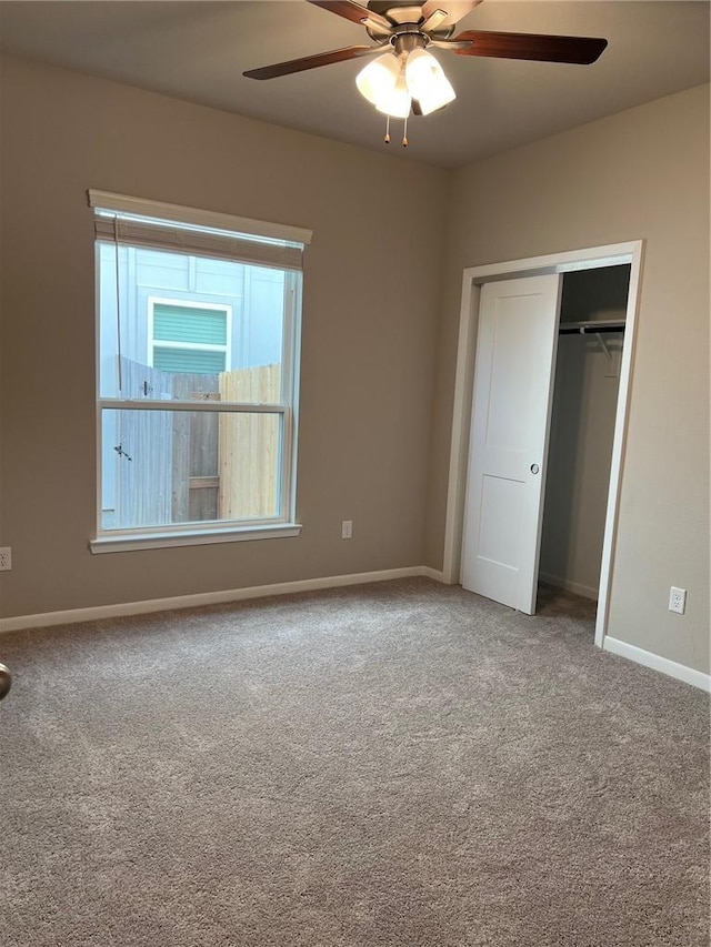 unfurnished bedroom featuring a closet, ceiling fan, and carpet flooring