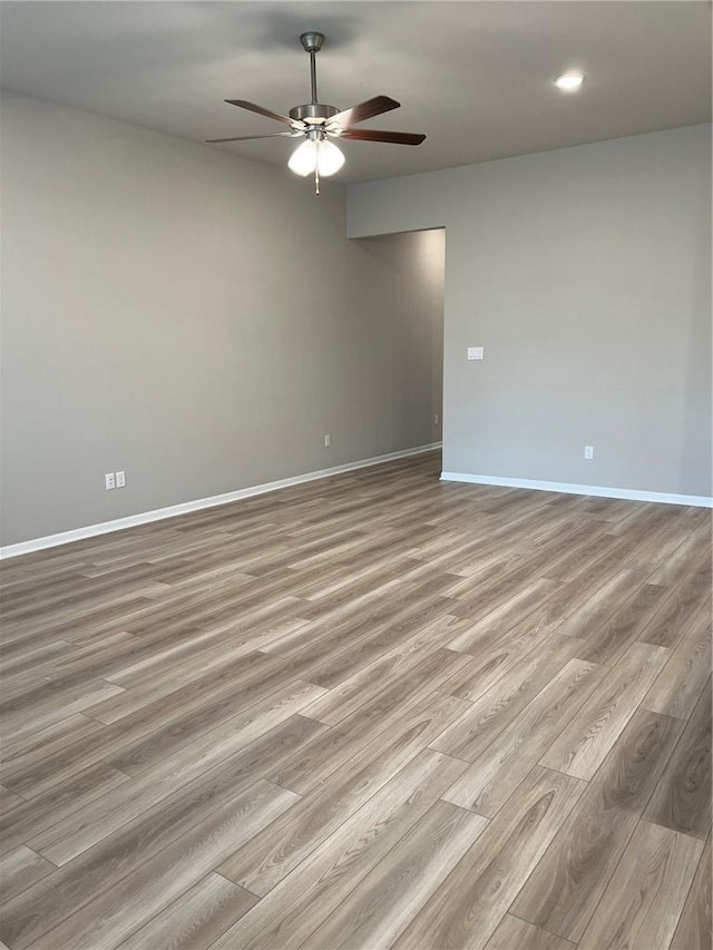 unfurnished room featuring ceiling fan and light wood-type flooring