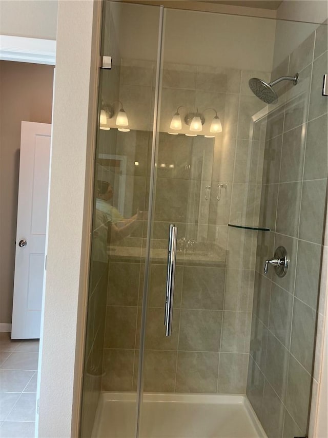 bathroom with walk in shower and tile patterned floors