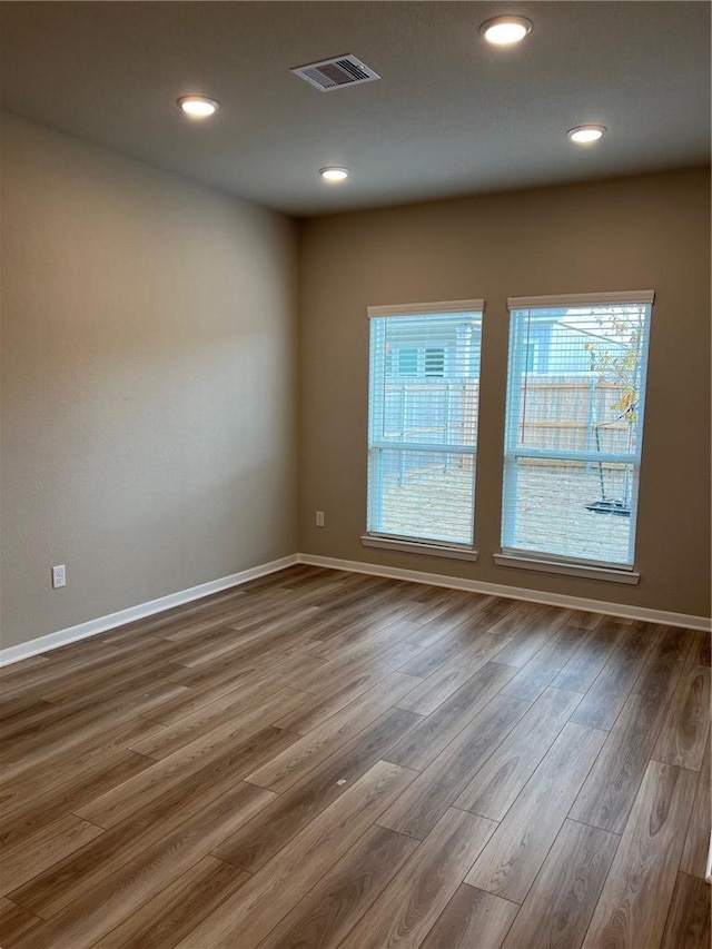 spare room with dark hardwood / wood-style floors