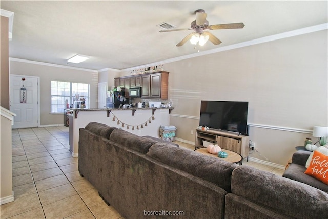 202 Forest Dr, College Station, TX 77840 - living area with light tile patterned floors, a ceiling fan, crown molding, and baseboards
