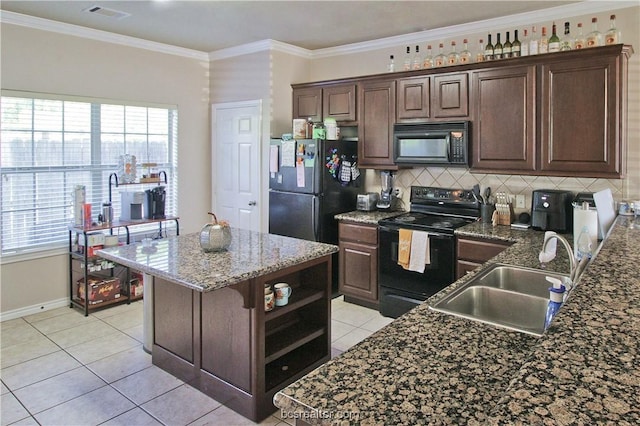 202 Forest Dr, College Station, TX 77840 - kitchen with black appliances, a sink, tasteful backsplash, light tile patterned floors, and dark brown cabinets