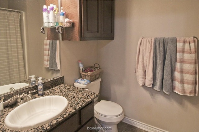 202 Forest Dr, College Station, TX 77840 - bathroom featuring vanity, toilet, baseboards, tile patterned flooring, and curtained shower