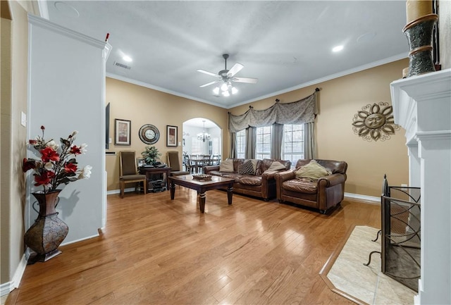 living room with ceiling fan, light hardwood / wood-style floors, and ornamental molding