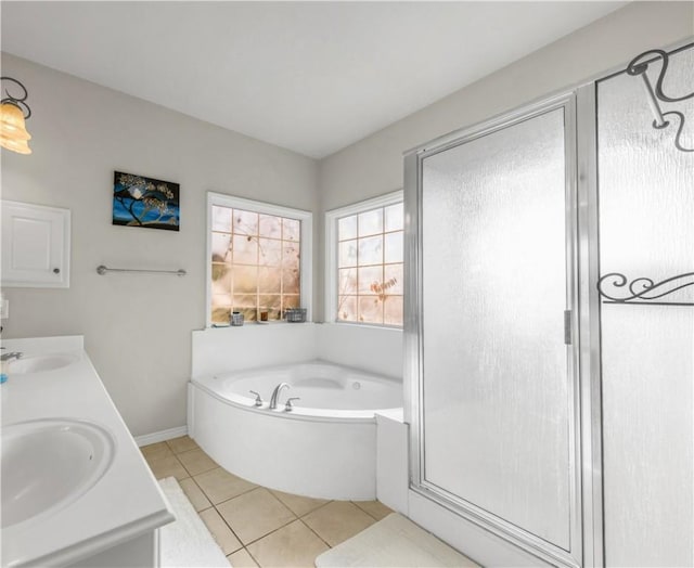 bathroom featuring shower with separate bathtub, vanity, and tile patterned floors