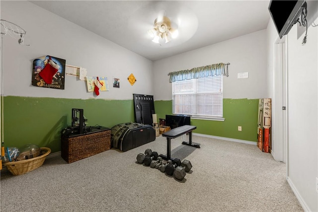 workout room featuring carpet and ceiling fan