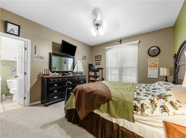 carpeted bedroom with ceiling fan and connected bathroom