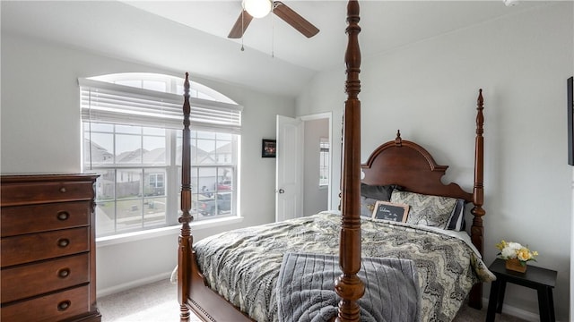 bedroom with ceiling fan, vaulted ceiling, baseboards, and light carpet