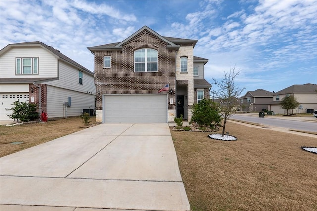 traditional home with concrete driveway, brick siding, a garage, and a front yard