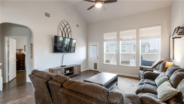 living area featuring a ceiling fan, visible vents, dark wood-style flooring, and high vaulted ceiling