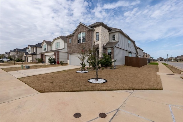 view of front of home featuring fence, a residential view, concrete driveway, a garage, and brick siding