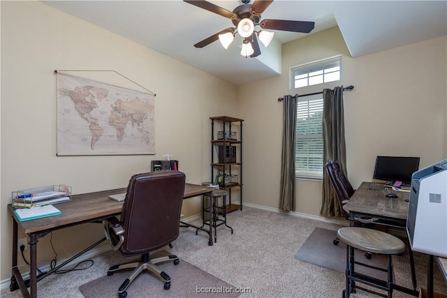 office space featuring light carpet and ceiling fan