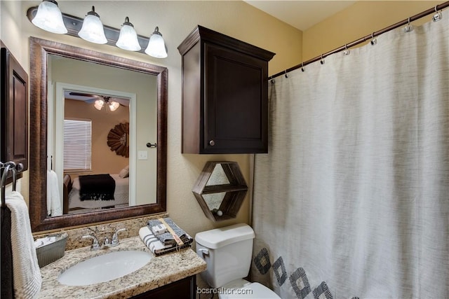 bathroom featuring vanity, toilet, and ceiling fan